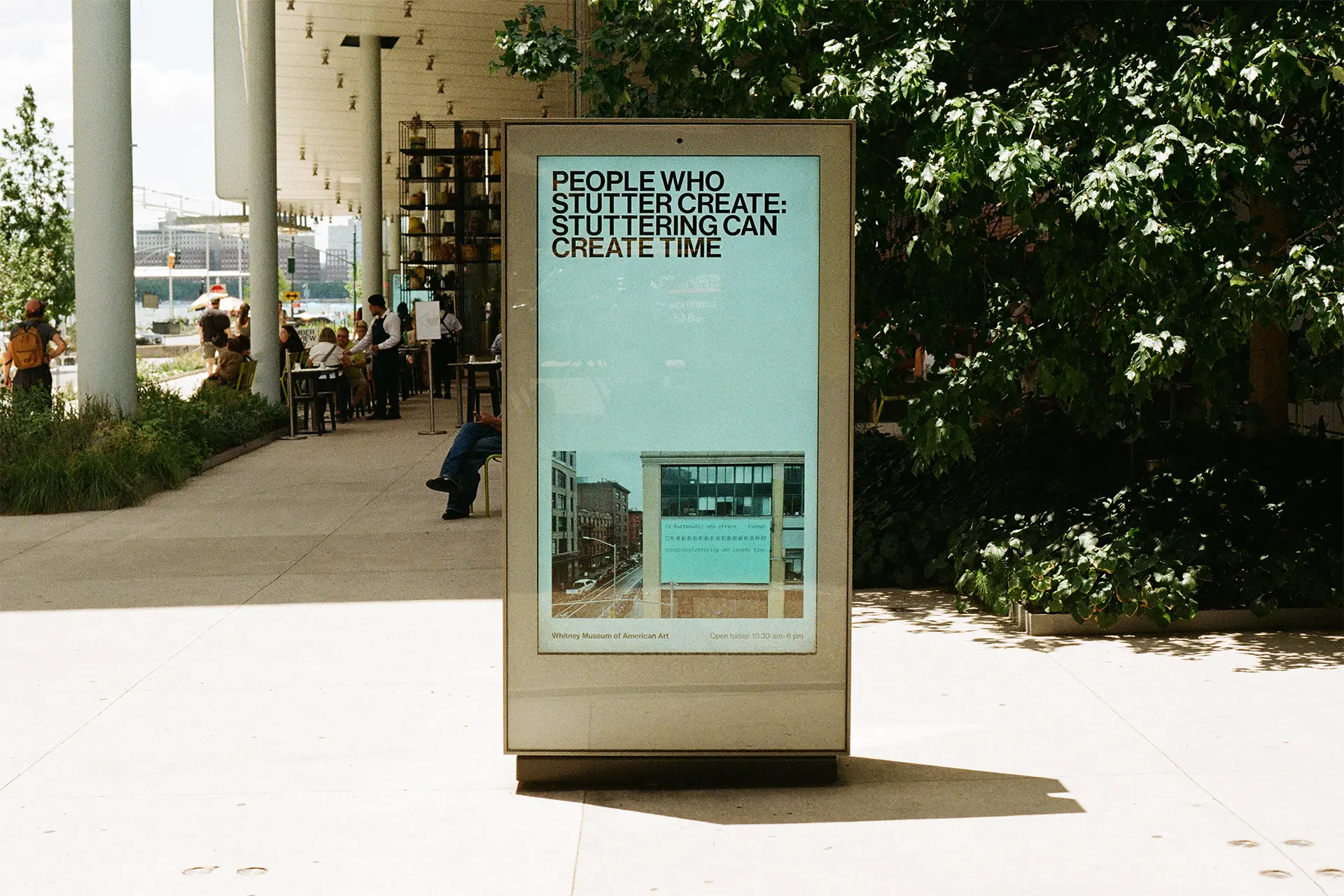 A digital poster box outside the Whitney Museum, displaying the billboard. 