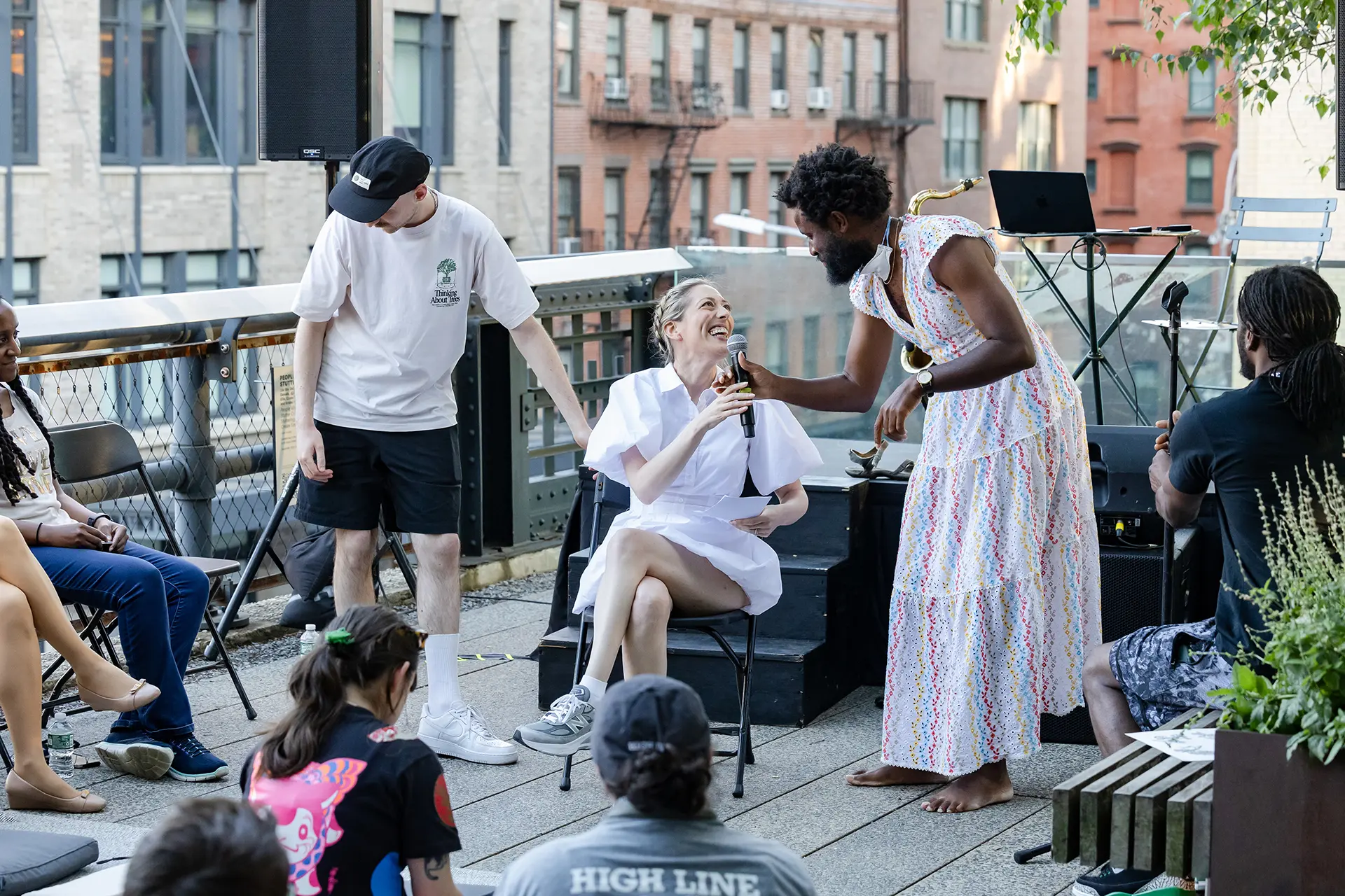 Three people are on stage, smiling.